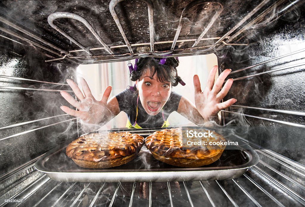 Funny chef perplexed and angry. Loser is destiny! Funny Housewife overlooked cakes in the oven, so she had scorched, view from the inside of the oven. Housewife perplexed and angry. Loser is destiny! Failure Stock Photo