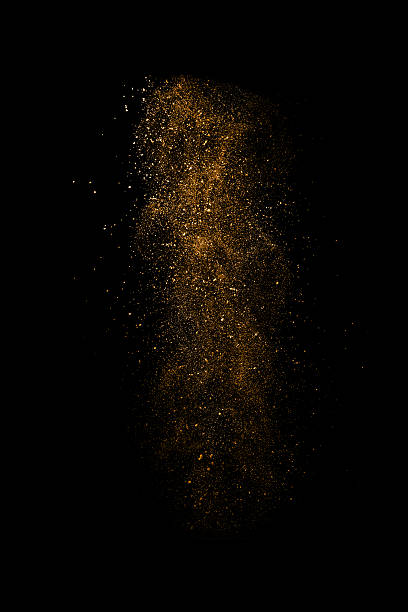 istock Stop motion of orange dust explosion isolated on black backgroun 524231269