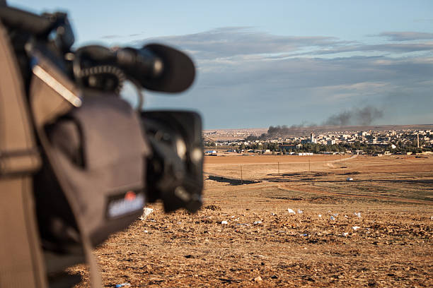 News camera shoots bombs in Kobani, Syria from border stock photo