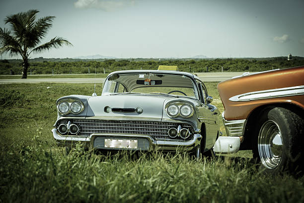 fragment of old vintage retro classic cars in the field stock photo