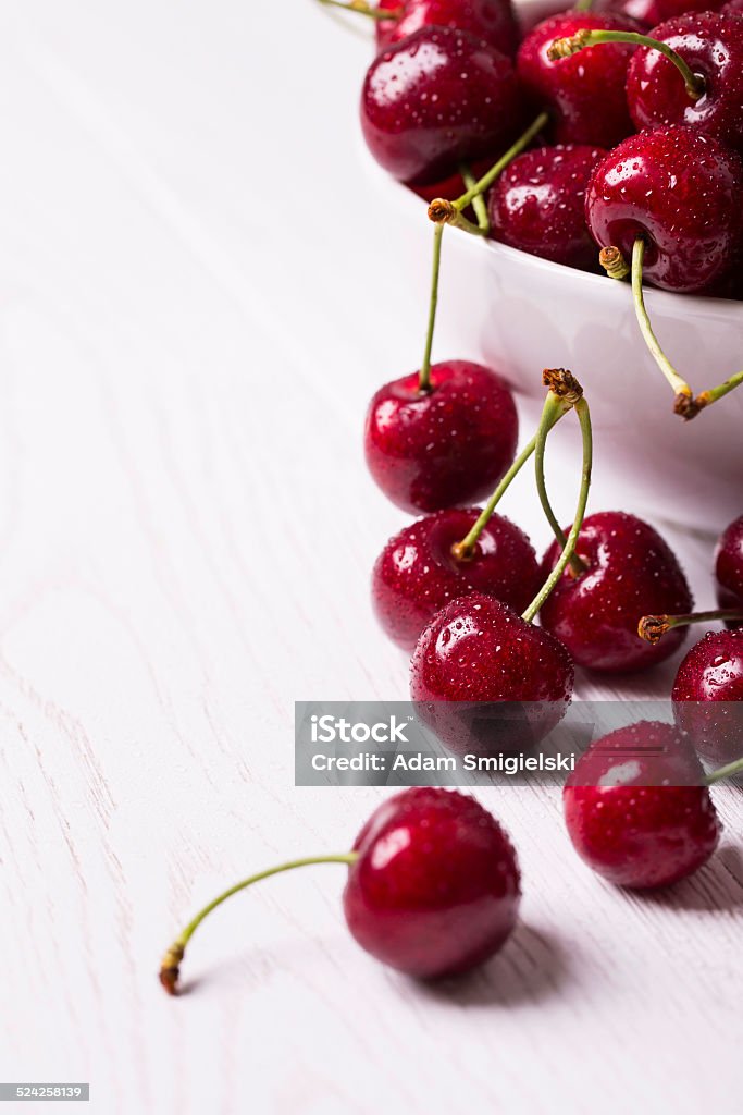 cherry fresh cherry on white wooden table Bowl Stock Photo