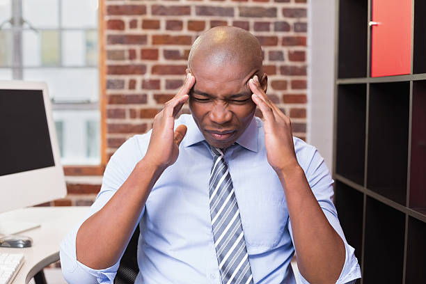istock Businessman with severe headache in office 524260189