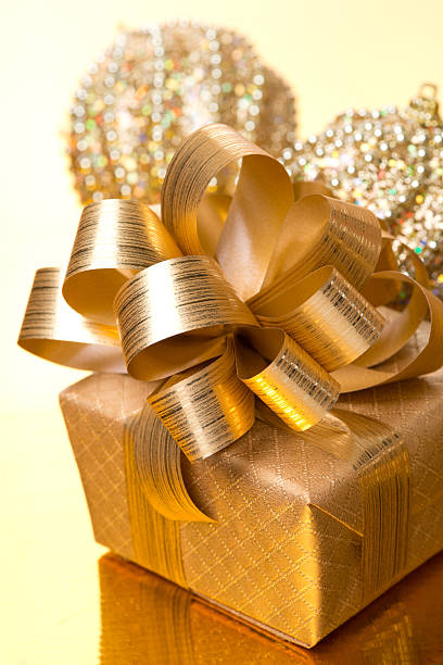 istock Christmas gift box and ornaments on golden background 524260991