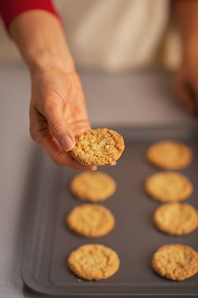 istock closeup on woman showing christmas cookie from pan 524262775