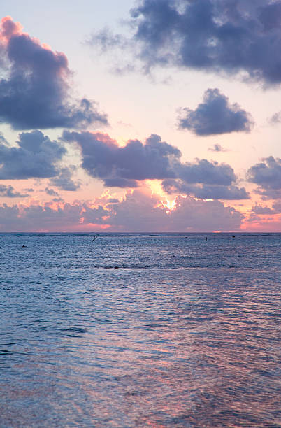 istock Sun sinks to Sea under a cloud-filled Sky at Sunset 524263967