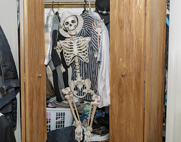 istock Skeleton sitting in the wardrobe-closet, wearing a white hat 524283669