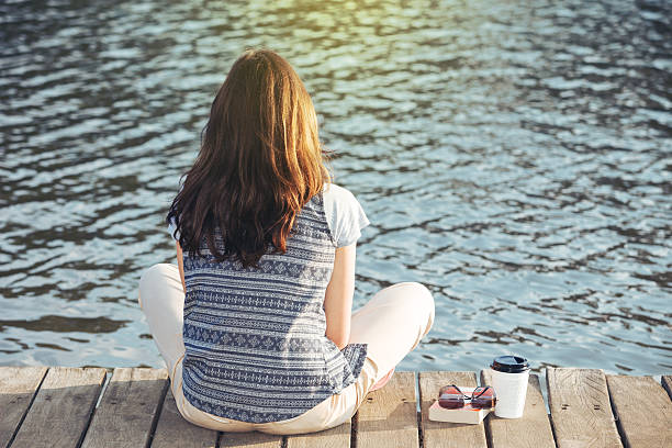 istock young girl resting on a pier 524283981