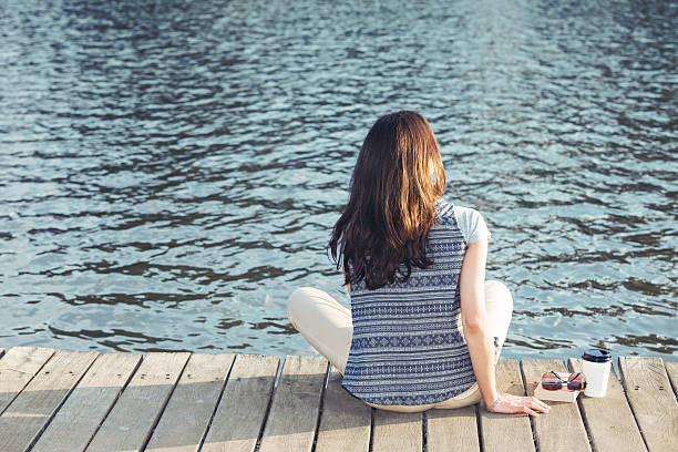 istock young girl resting on a pier 524284811
