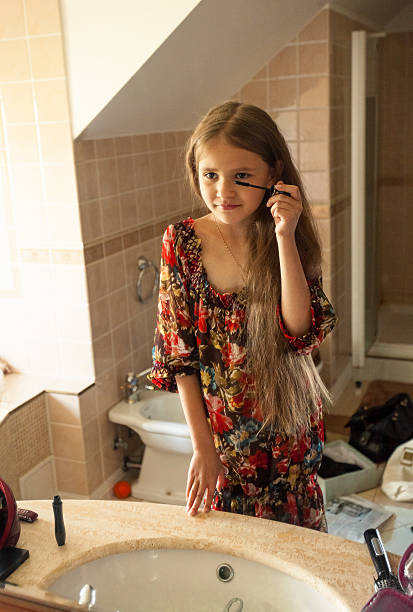 istock girl applying mascara at bathroom 524287189