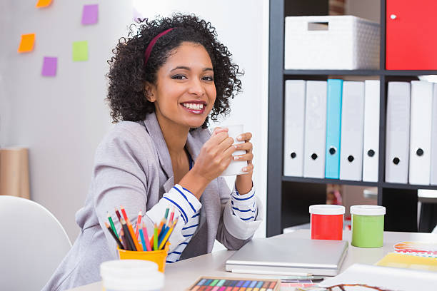 istock Female interior designer with coffee cup at desk 524287245