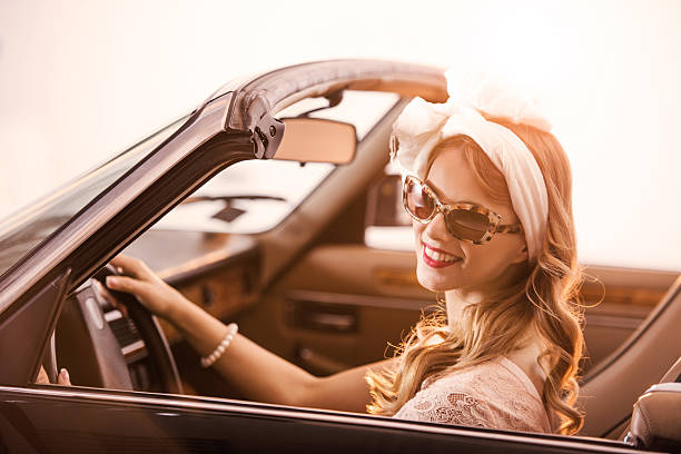 istock Retro style woman in old timer car. 524287507