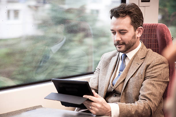 istock Businessman Travelling by Train and Working 524289031