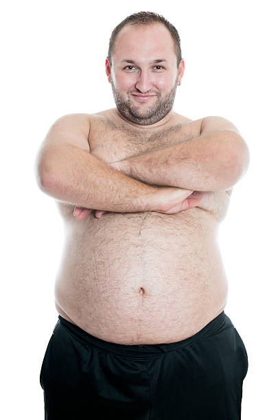 Overweight or Fat Shirtless Man Proudly Showing his Large Belly Overweight or Fat Shirtless Man Proudly Showing his Large Belly and smiling. Isolated on White. fat guy no shirt stock pictures, royalty-free photos & images