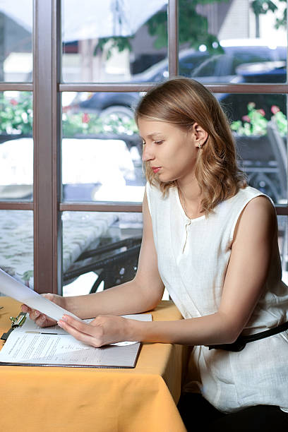 istock Woman reads documents sitting near the window 524296799