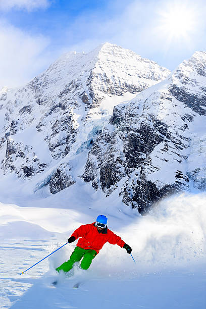 istock Freeride in fresh powder snow - man skiing downhi 524296853