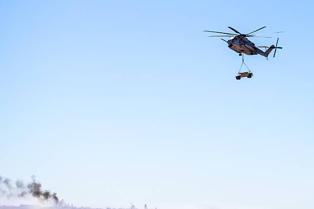 istock CH-53E Super Stallion (Sikorsky) Helicopter carrying military humvee 524297921