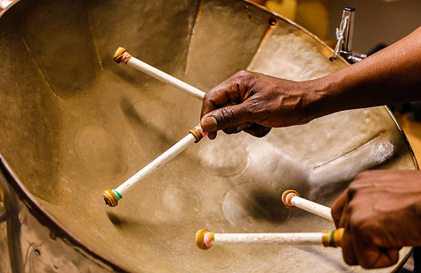 Steel drummmer Steel drummmer with four sticks caribbean culture stock pictures, royalty-free photos & images