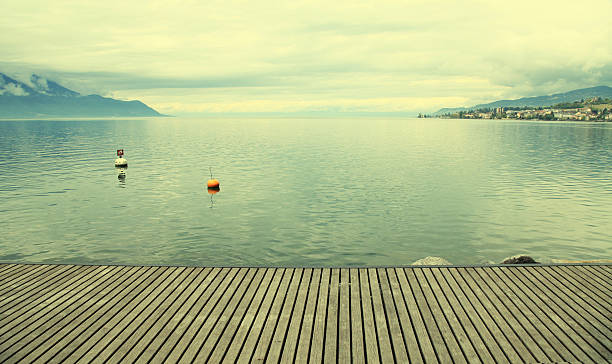 Empty gray wooden pier on Lake Geneva, Montreux, Switzerland. Toned image