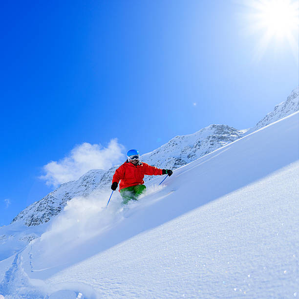 istock Freeride in fresh powder snow - man skiing downhi 524300717
