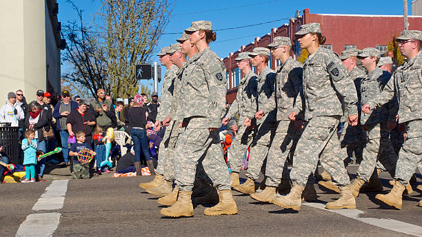 Veterans Day Parade Albany Oregon National Guard 82 Brigade Albany, Oregon, USA - November 11, 2014 : This part of the parade on Lyon Street and 2nd Ave shows soldiers of the Oregon National Guard : Oregon National Guard 82 Brigade marching. Some of the large crowd of people are seen in the background. This large Veteran's Day Parade is held annually in Albany, Oregon. national guard stock pictures, royalty-free photos & images