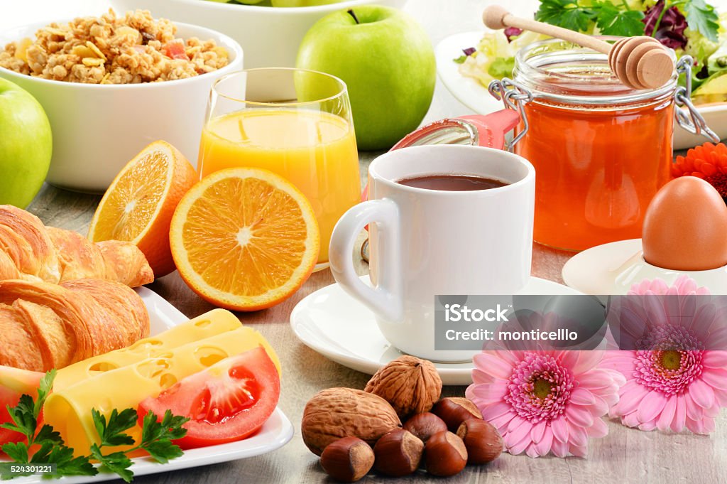 Composition with breakfast on the table. Balnced diet. Breakfast consisting of fruits, orange juice, coffee, honey, bread and egg. Balanced diet Apple - Fruit Stock Photo