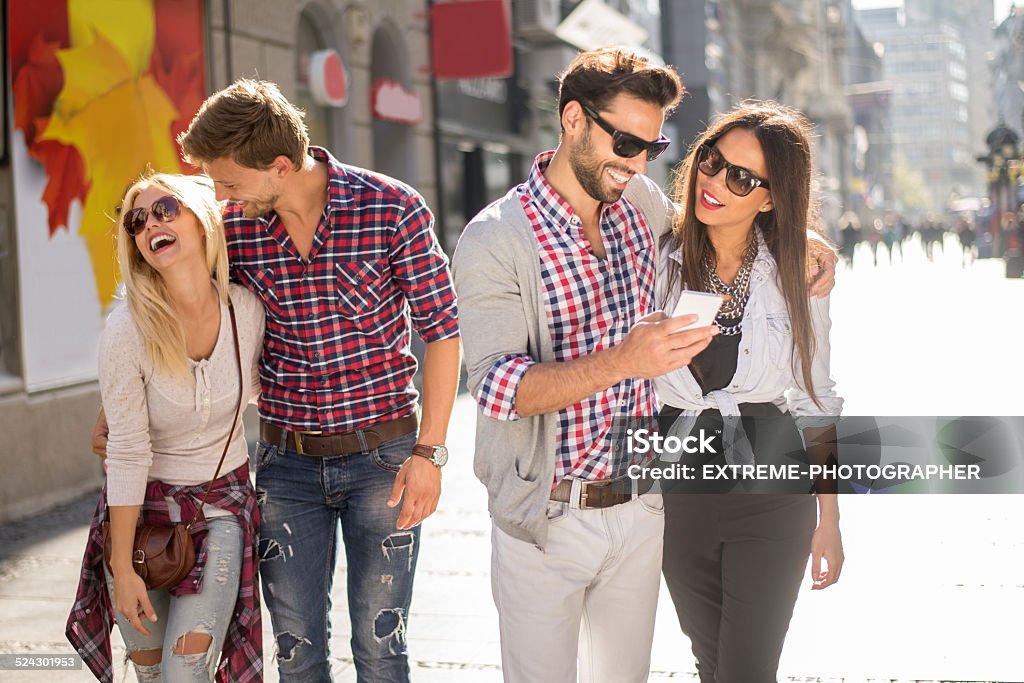 Youth in the city Two couples walking in the city street. They all seem happy and full of life. Adult Stock Photo