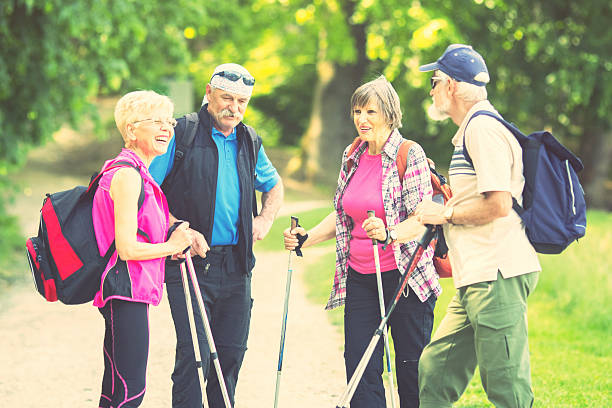 istock Four seniors hiking in the forest, talking, planning 524323429