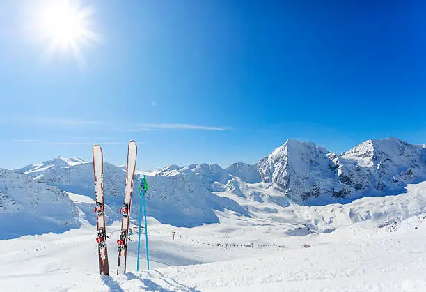 Skiing equipments on ski slope in italian Alps