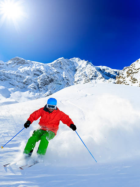Freeride in fresh powder snow - man skiing downhi stock photo