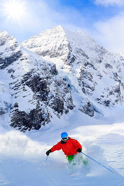 istock Freeride in fresh powder snow - man skiing downhi 524324325
