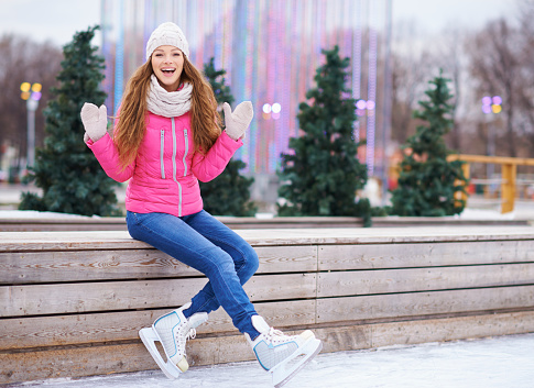Portrait of a beautiful young woman having fun on an ice rink