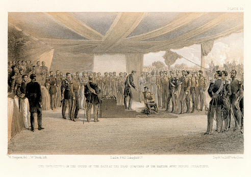 Vintage engraving showing a scene from the Crimean War 1853 to 1856, a conflict in which Russia lost to an alliance of France, Britain, the Ottoman Empire, and Sardinia.  The Investiture of the Order of the Bath at the Head Quarters of the British Amry before Sebastopol.