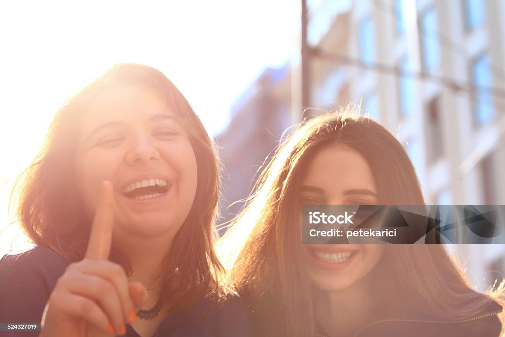 Best Friends Laughing in Street Close-up two beautiful young women laughing with ample copyspace. 18-19 Years Stock Photo