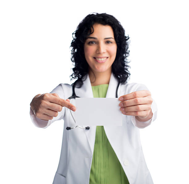 istock Female doctor showing empty business card 524327227