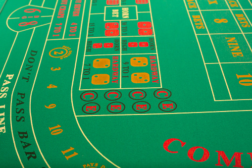 Casino roulette table with gambling chips and glass of whiskey. Property released.