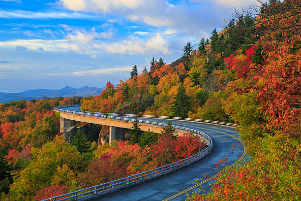 Linn Cove Viaduct - Blue Ridge parkway fall Linn Cove Viaduct on the Blue Ridge parkway in the fall season. Road winding through the mountains with autumn colors and blue vibrant morning skies. blue ridge mountains photos stock pictures, royalty-free photos & images