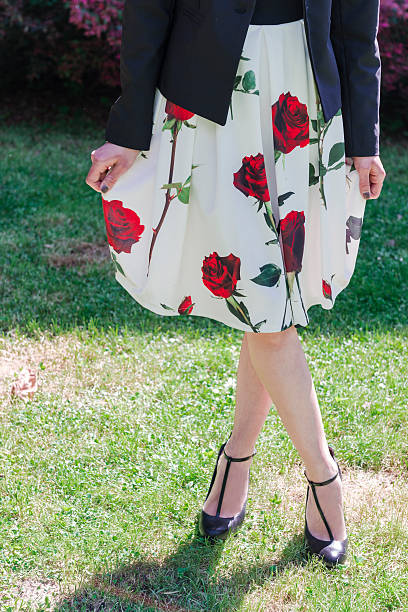 girl wearing a floral dress you can see the legs and the white dress painted with roses. The girl is wearing a blazer,too puff ball gown stock pictures, royalty-free photos & images