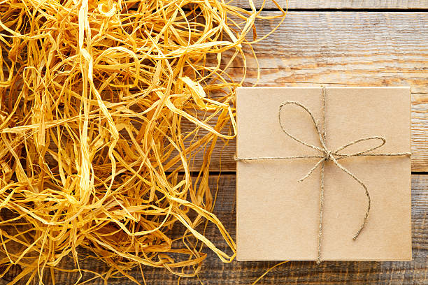 istock kraft gift box on wooden table with raffia or twine 524369898