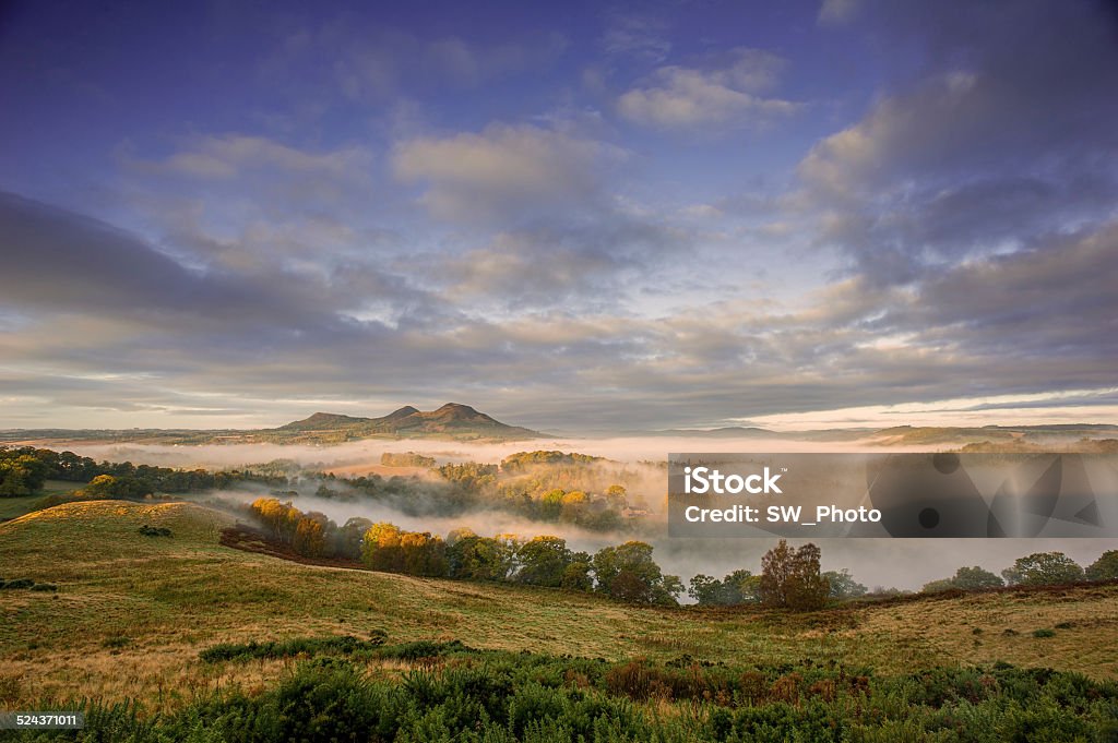 Eildon Hills in the Scottish Borders Sun rising over the Eildon Hills in the Scottish Borders during autumn Melrose Abbey Stock Photo