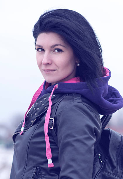 istock Outdoors beautiful young brunette woman posing in a black leather 524371568