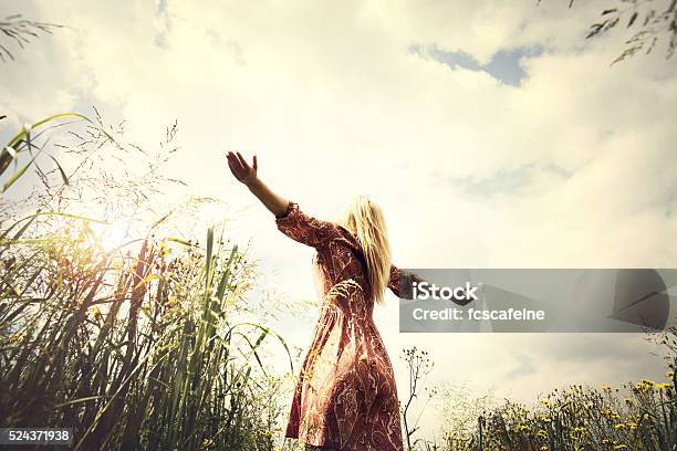 Young Woman Enjoying Nature In The Middle Of A Meadow Stock Photo - Download Image Now
