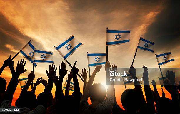 Group Of People Waving The Flag Of Israel Stock Photo - Download Image Now - Israeli Flag, Israel, Flag