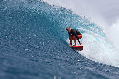 An older man gets barreled on a wave in good style