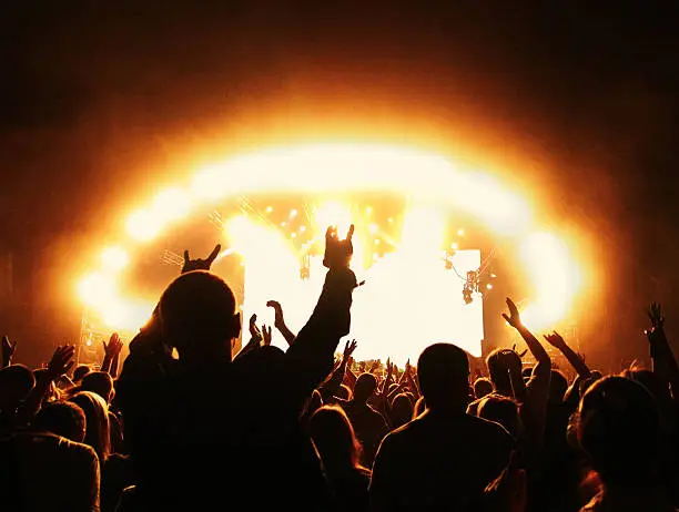 Photo of Crowd at rock concert in front of illuminated stage