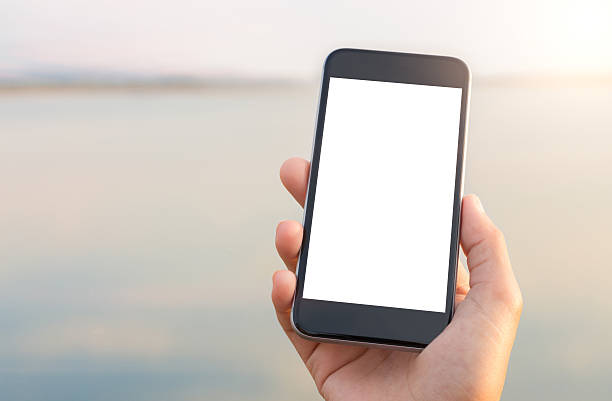 istock hand holing phone white screen at outdoor lifestyle 524380116