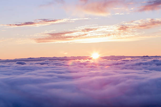 Divine sunset above the clouds stock photo