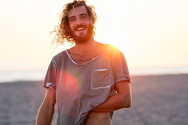 Happy man at the beach Portrait of young bearded man at the beach hot handsome man stock pictures, royalty-free photos & images