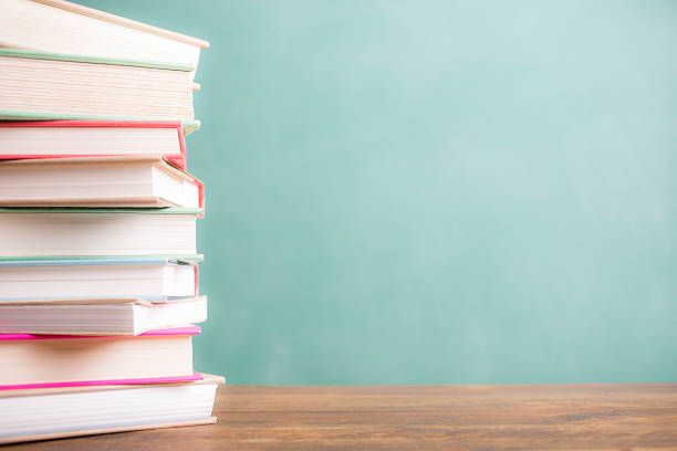 istock Back to school. Education. Textbooks stacked on desk. Chalkboard. 524381902
