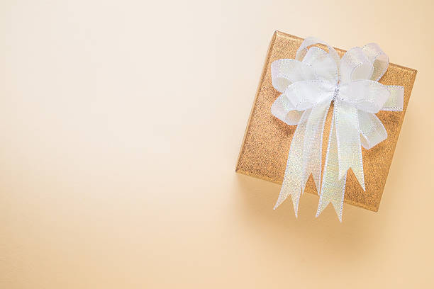 istock Luxury golden gift box on brown background 524383560