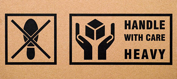 istock Signs Do not step and Handle with care Heavy 524386560